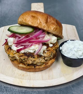 ✨Today's Feature✨ Greek Chicken Burger Freshly ground chicken breast and thighs served on a brioche bun, red onions, cucumbers topped with feta and a side of Tzatziki $12